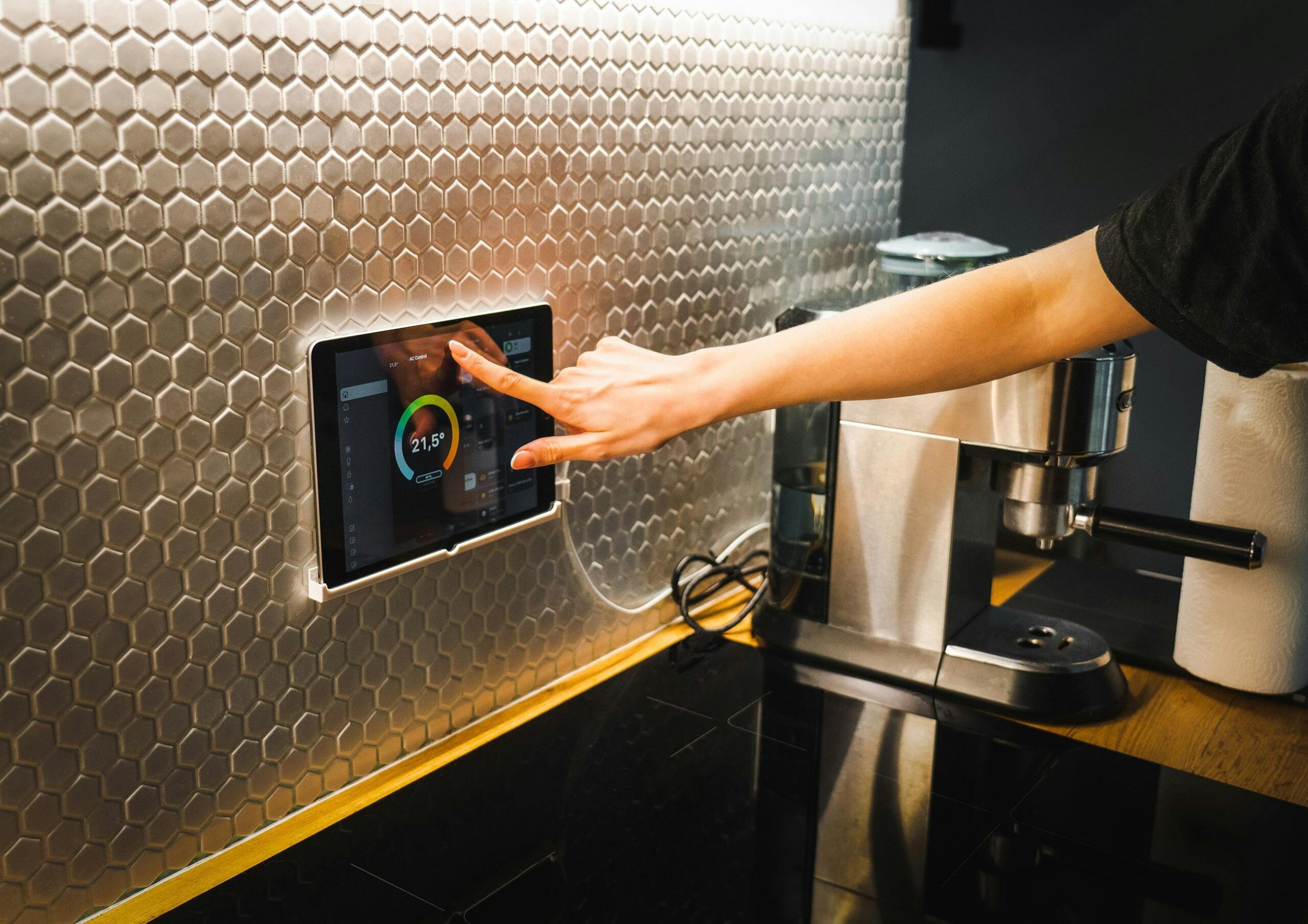 Modern kitchen featuring sleek smart coffee maker next to other IoT devices