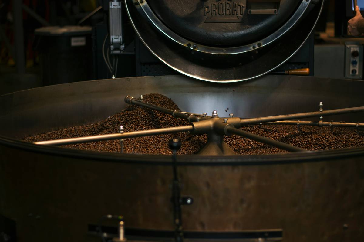 A steaming cup of coffee brewed using advanced brew mode options, sitting atop a wooden table.