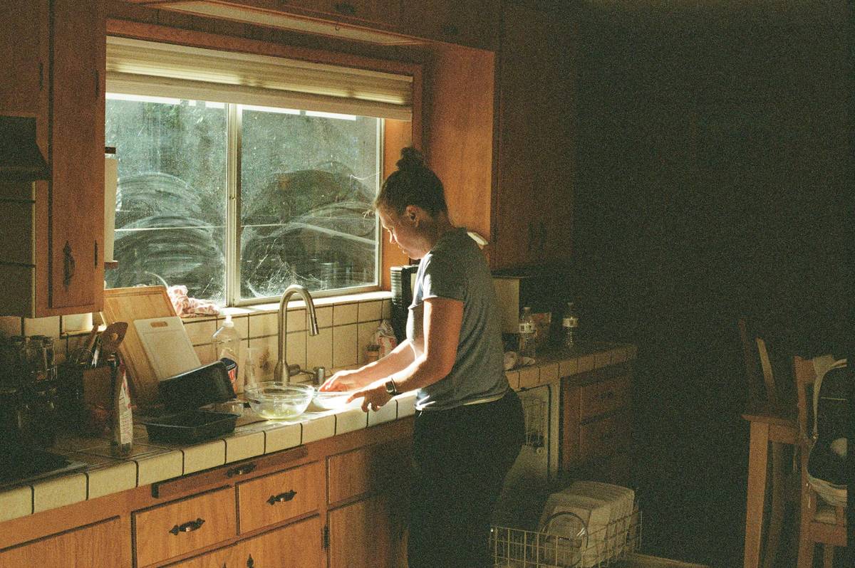 Happy woman holding a shiny, well-maintained smart coffee maker