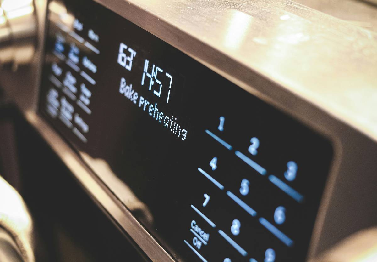 Side-by-side image of a smart coffee maker and compatible grinder.