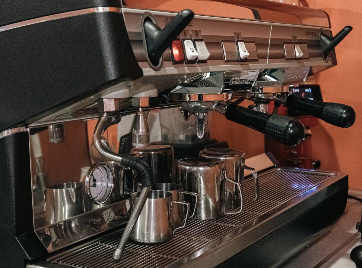A sleek smart coffee maker brewing coffee in a modern kitchen