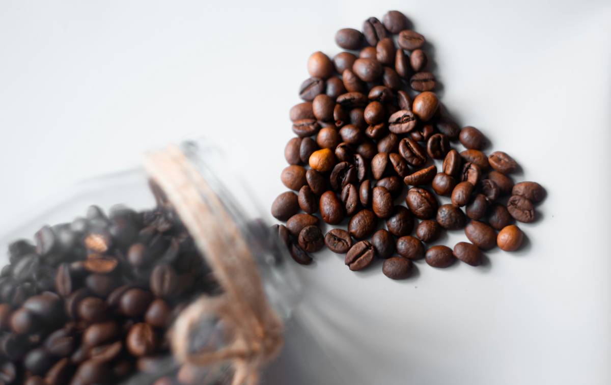 Close-up shot of fresh coffee beans on a wooden table