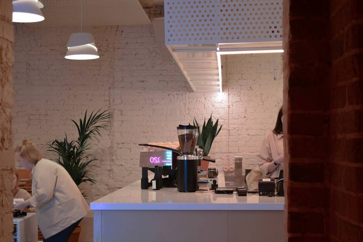 A sleek smart coffee maker on a kitchen counter displaying its digital interface