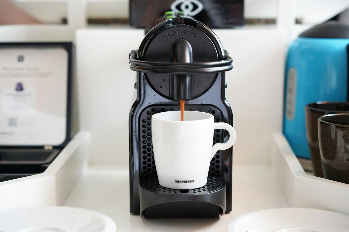 Cross-section diagram showing biofilm buildup in smart coffee maker water lines vs. clean lines
